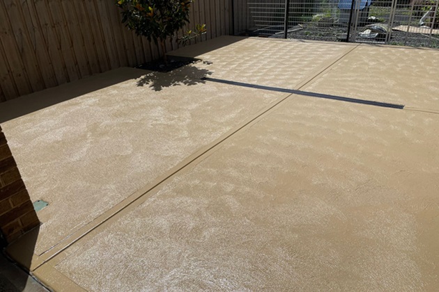 Rustic-style patio with warm-toned coloured concrete