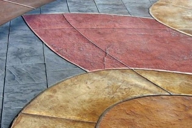 Elegant courtyard featuring stamped coloured concrete in a terracotta hue with intricate patterns