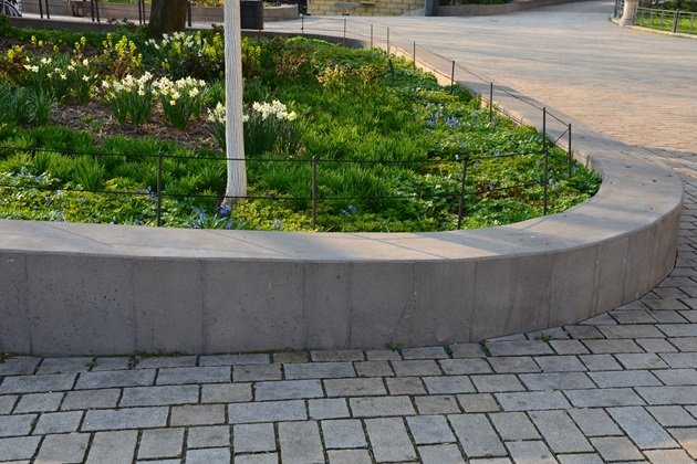 Tiered concrete retaining walls creating distinct planting areas